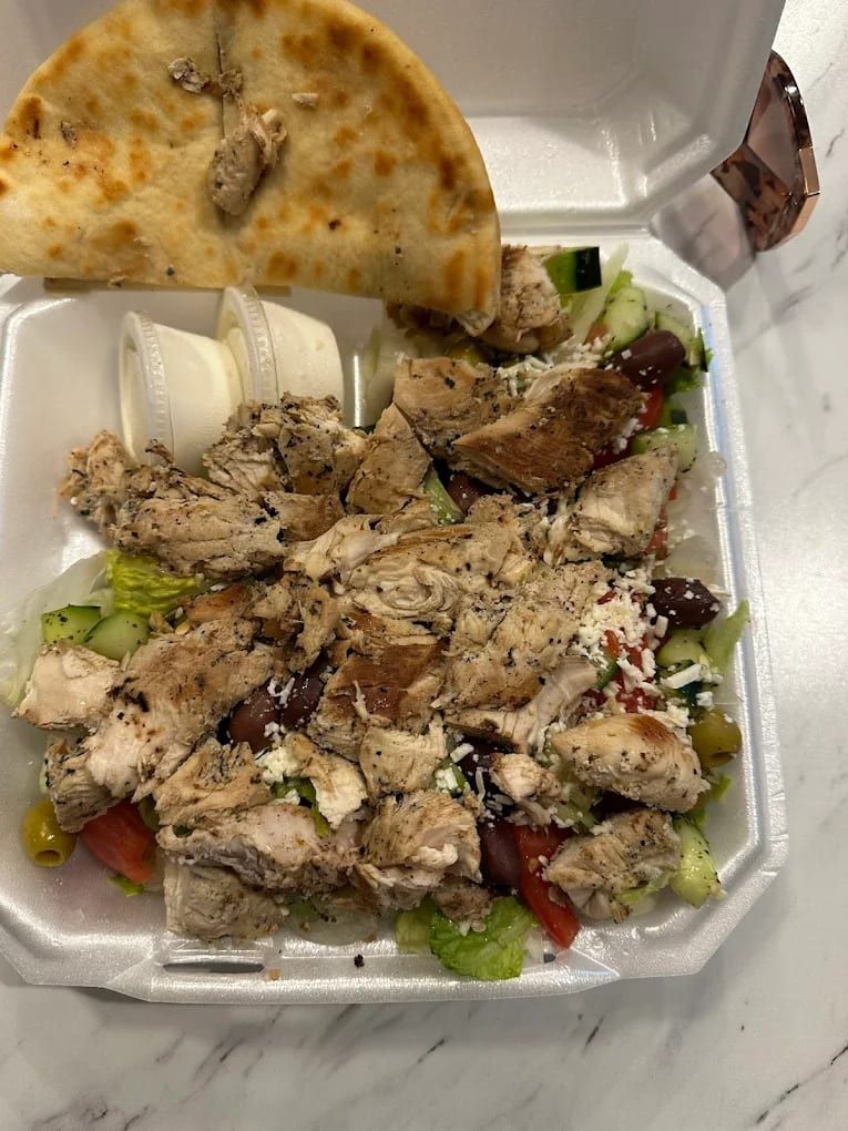 Grilled chicken over rice and salad with pita, to go